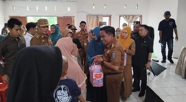 Pj Bupati Jeneponto, Junaedi Bakri saat menyerahkan bantuan pangan ke salah seorang warga di Kecamatan Turatea. (Foto :Ist).