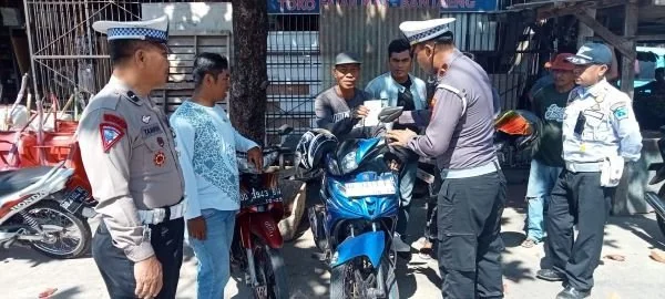 Satlantas Polres Bantaeng memberikan himbauan menyelenggarakan sosialisasi Ops Keselamatan  2024 dengan memberikan stiker dan brosur.