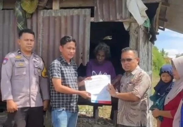 Kadis Dukcapil Jeneponto, Mustaufiq bersama Kades Jombe Junaedi dan Babinkantibmas Ipda Zulfikar saat menyerahkan Dokumen kependudukan dan sembako ke Kakek Yasang. Dok. Ist
